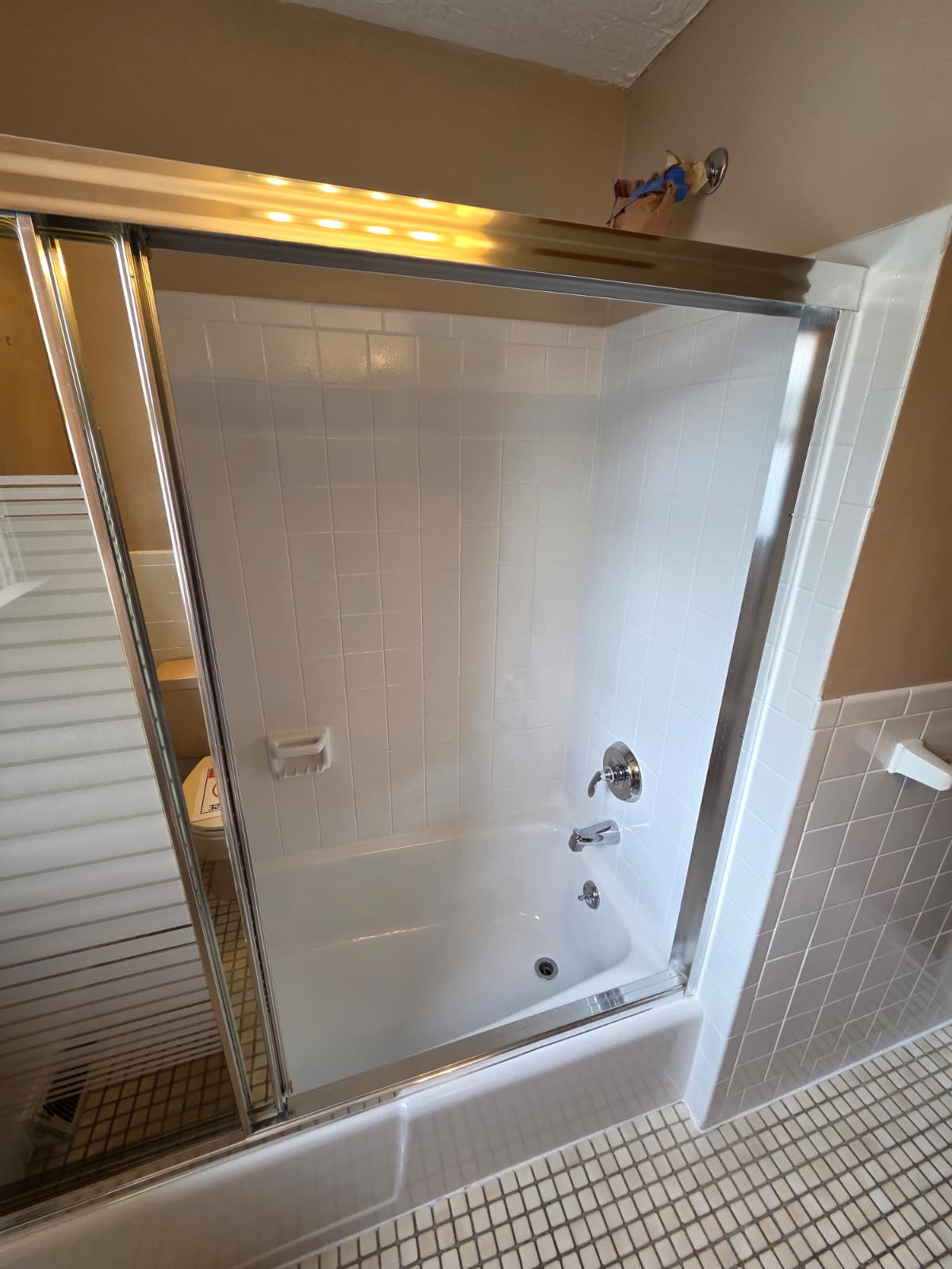 Clean bathroom with a refinished-style bathtub